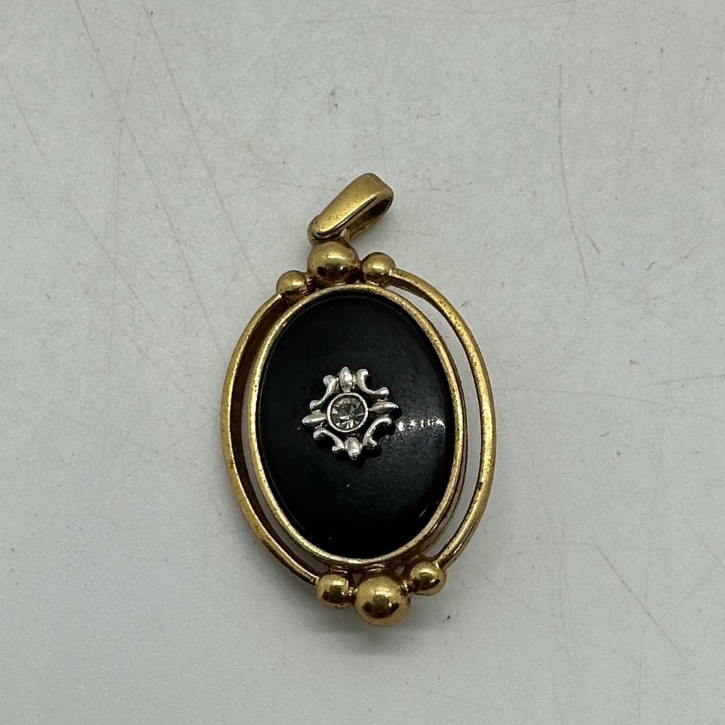 Gold-Tone Black Oval Pendant With Decorative Accent